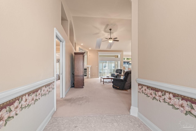 corridor with vaulted ceiling and light colored carpet