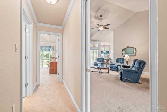 hall with crown molding, light colored carpet, and vaulted ceiling