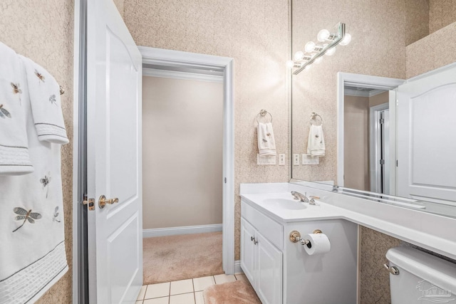 bathroom with tile patterned flooring, vanity, crown molding, and toilet