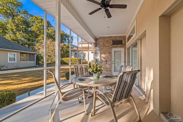 sunroom / solarium featuring ceiling fan