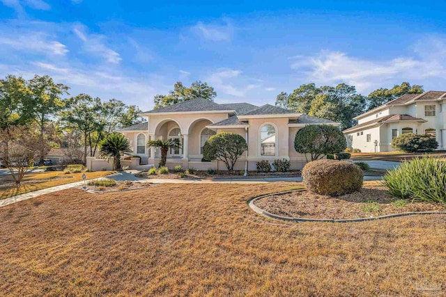 mediterranean / spanish house with a front lawn