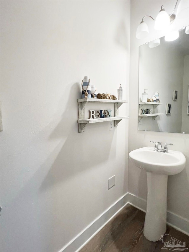 bathroom with hardwood / wood-style flooring and sink