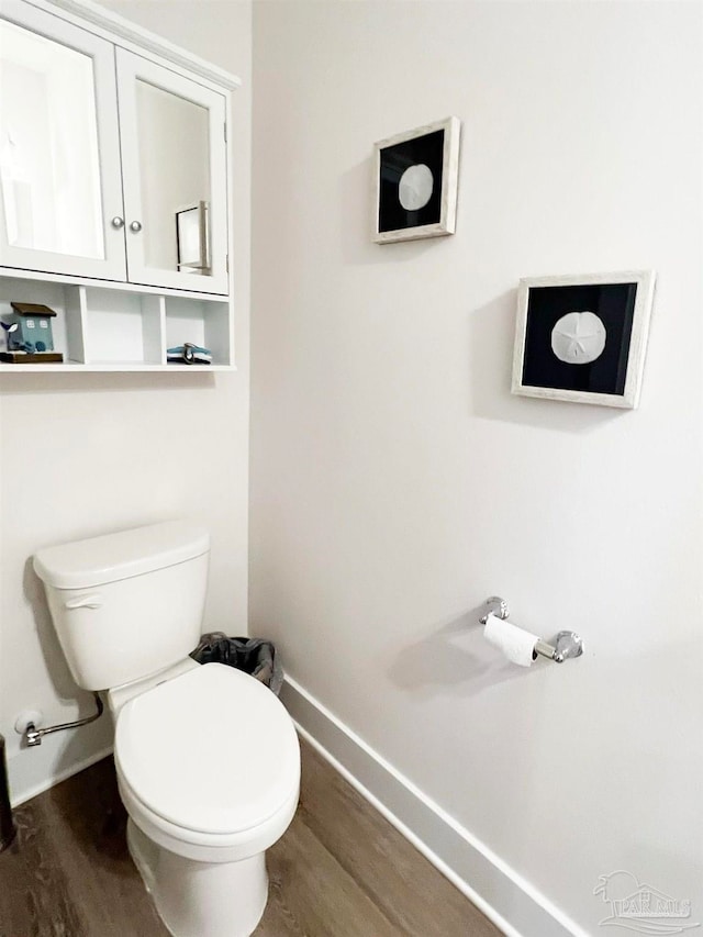 bathroom featuring wood-type flooring and toilet