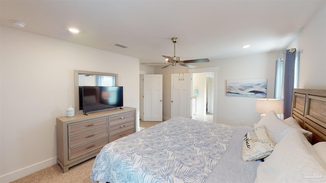 bedroom featuring ceiling fan and light colored carpet