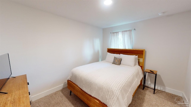 bedroom featuring light colored carpet