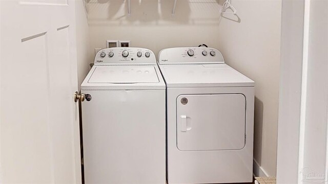 clothes washing area featuring separate washer and dryer