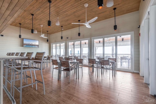 dining space with ceiling fan, light wood-type flooring, high vaulted ceiling, and wooden ceiling