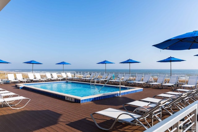 view of pool featuring a deck with water view