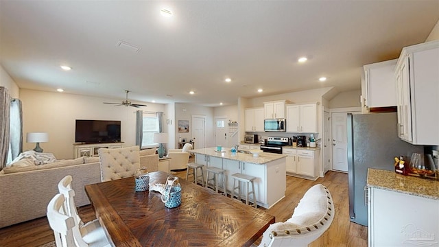 dining area featuring light hardwood / wood-style floors and ceiling fan