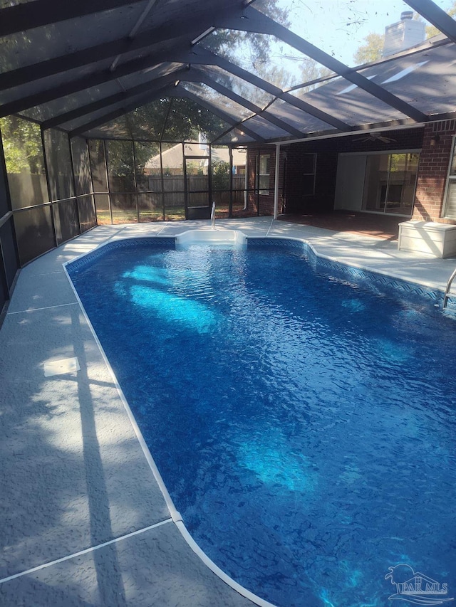 view of pool featuring a patio and glass enclosure