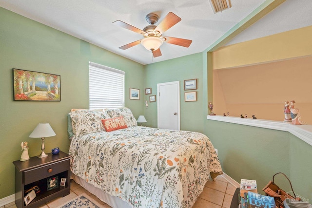 tiled bedroom with ceiling fan