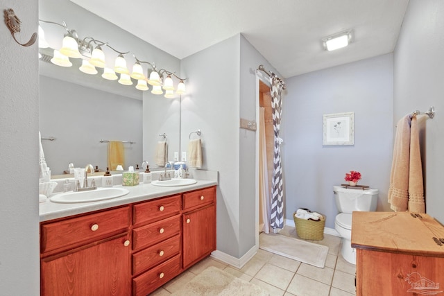 bathroom featuring tile patterned flooring, vanity, walk in shower, and toilet