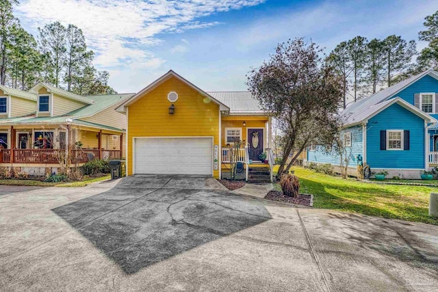 view of front of home featuring a porch, a garage, and a front lawn