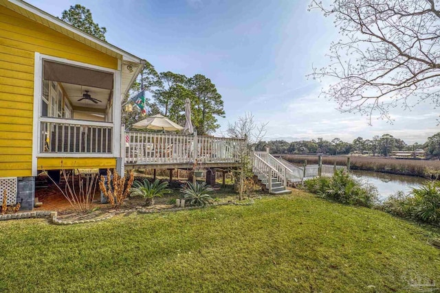 view of yard featuring a deck with water view