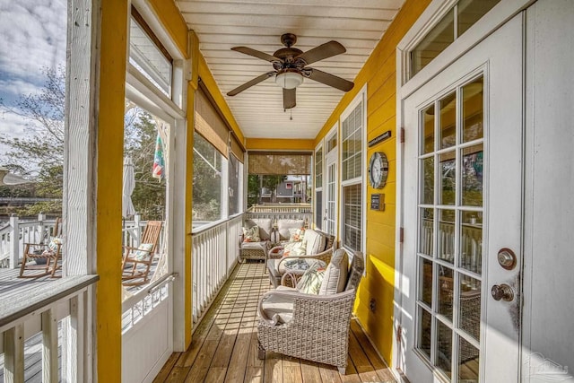 sunroom featuring ceiling fan