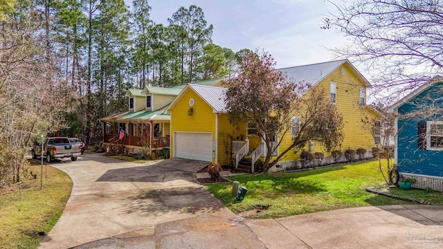 view of front of property featuring a garage, covered porch, and a front lawn