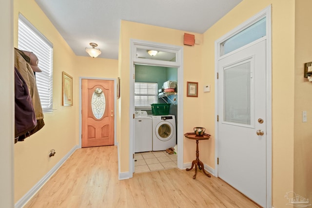 interior space with plenty of natural light, separate washer and dryer, and light hardwood / wood-style floors