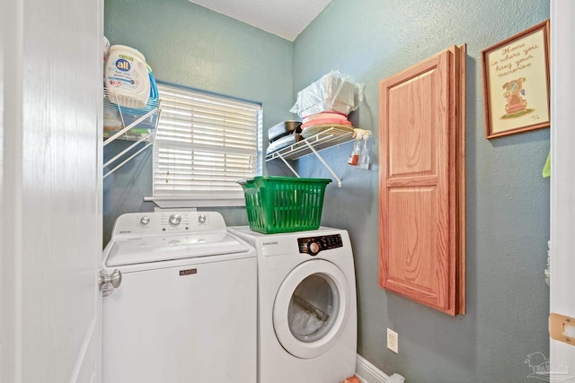 laundry area with independent washer and dryer and cabinets