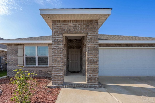 4616 Honor Guard Way, Crestview, FL 32539 - entrance to property with brick siding, driveway, an attached garage, and roof with shingles