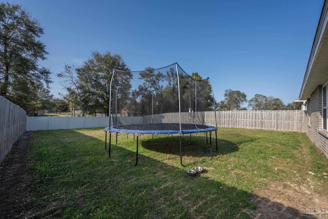 4616 Honor Guard Way, Crestview, FL 32539 - fenced backyard featuring a trampoline