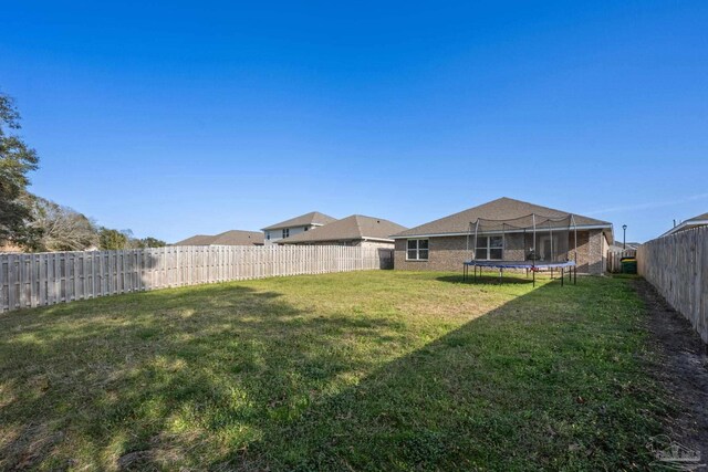4616 Honor Guard Way, Crestview, FL 32539 - fenced backyard with a trampoline