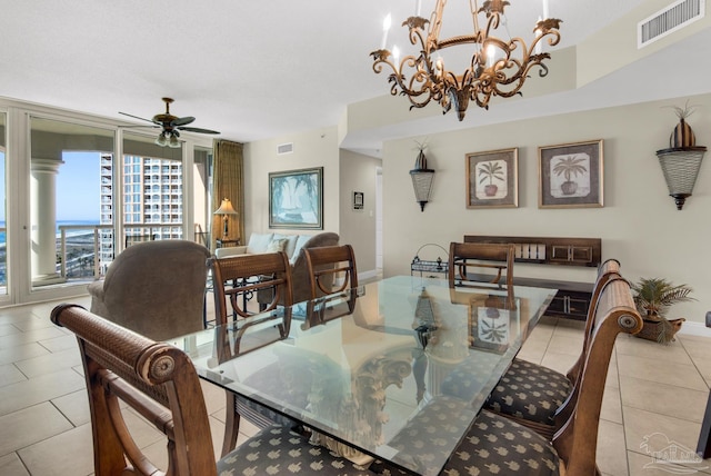 tiled dining room with ceiling fan with notable chandelier