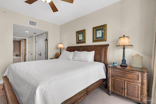 carpeted bedroom featuring ensuite bath and ceiling fan