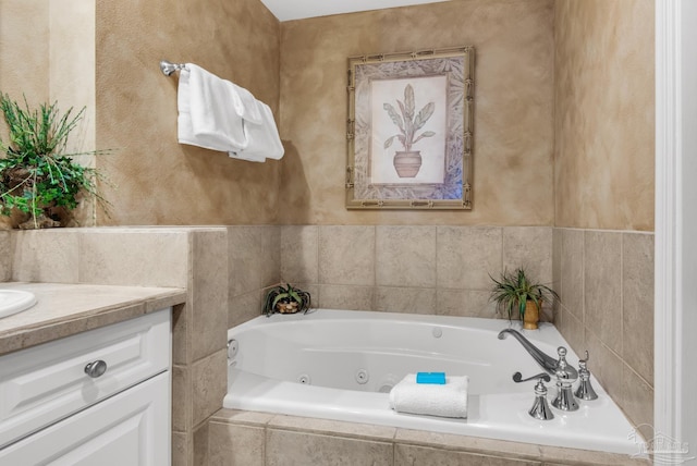 bathroom featuring tiled bath and vanity