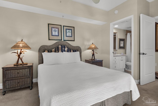 carpeted bedroom featuring connected bathroom