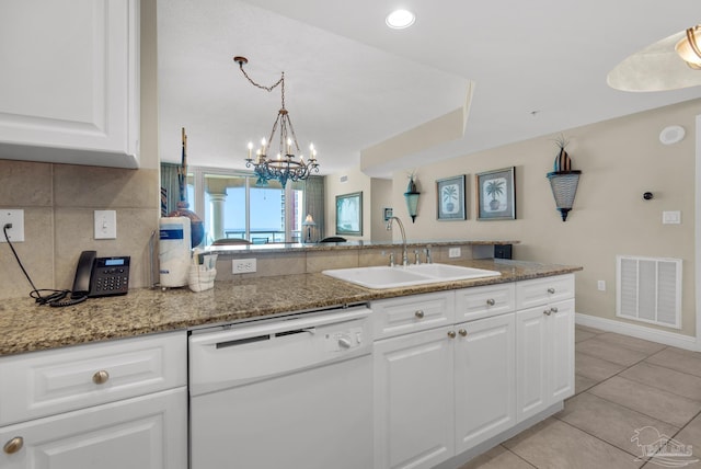 kitchen featuring light stone countertops, white dishwasher, sink, light tile patterned floors, and white cabinetry