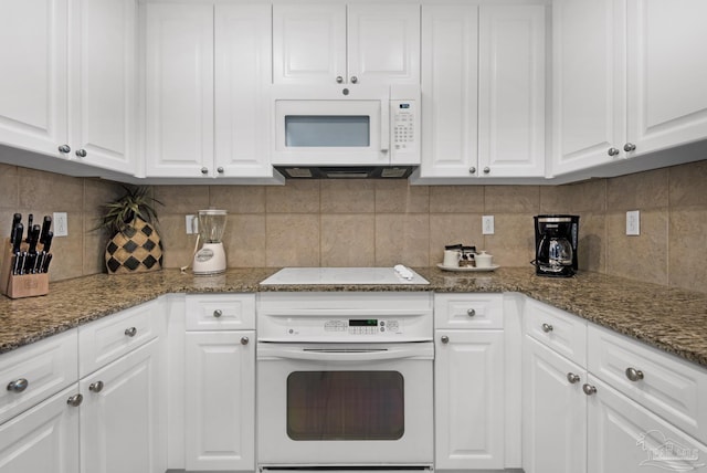 kitchen featuring white cabinetry, white appliances, and tasteful backsplash