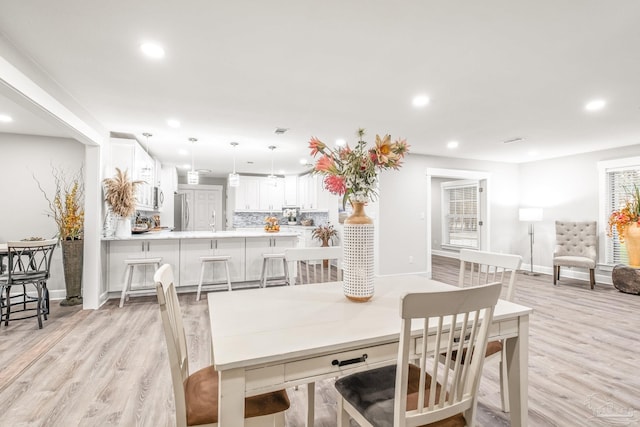 dining space with light hardwood / wood-style floors