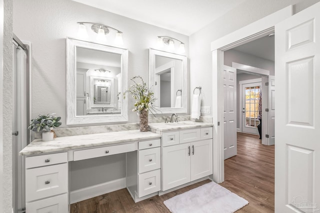 bathroom with vanity and wood-type flooring