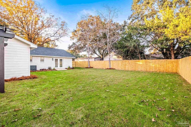 view of yard featuring cooling unit and french doors