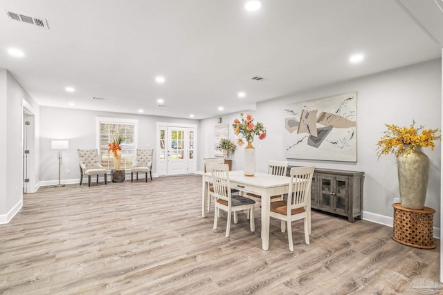 dining area with french doors and light wood-type flooring