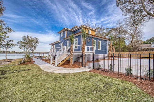 exterior space with a front lawn and a water view