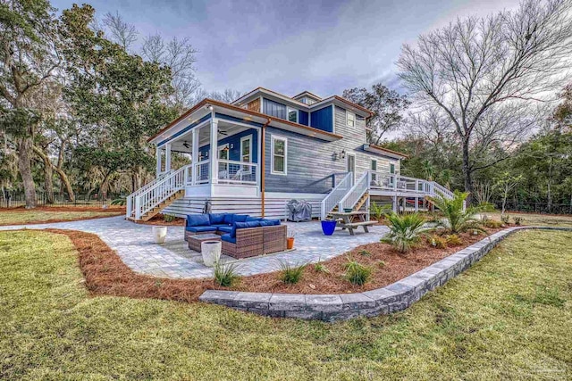 rear view of property with a yard, a patio area, outdoor lounge area, and ceiling fan