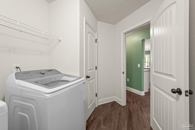 washroom featuring laundry area, a textured ceiling, baseboards, washer / dryer, and dark wood-type flooring