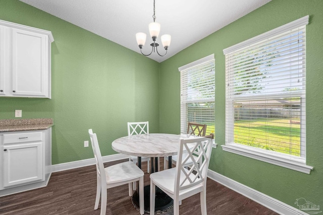 dining room with dark wood-style flooring, baseboards, and an inviting chandelier