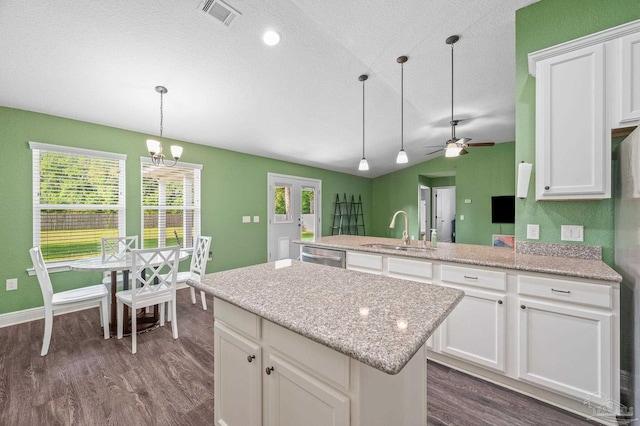 kitchen featuring a sink, dishwasher, ceiling fan with notable chandelier, visible vents, and dark wood-style floors