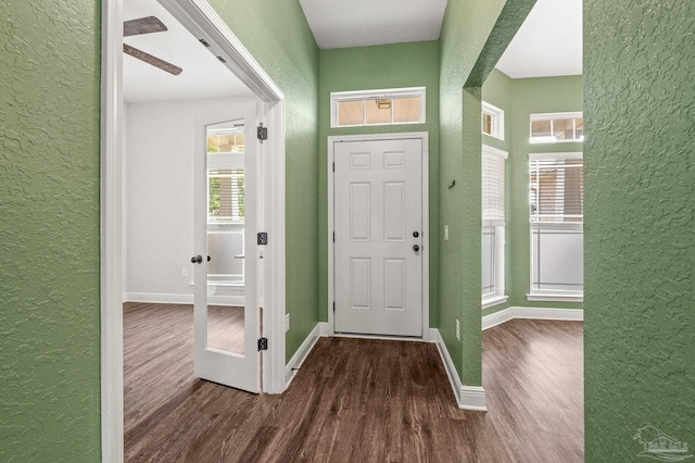interior space featuring a textured wall and wood finished floors
