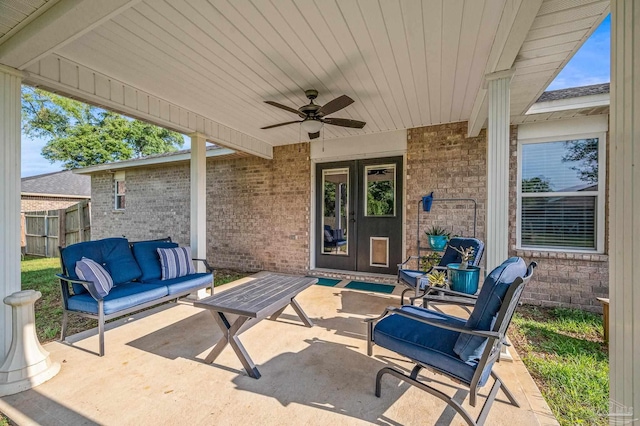 view of patio / terrace featuring french doors, fence, outdoor lounge area, and a ceiling fan