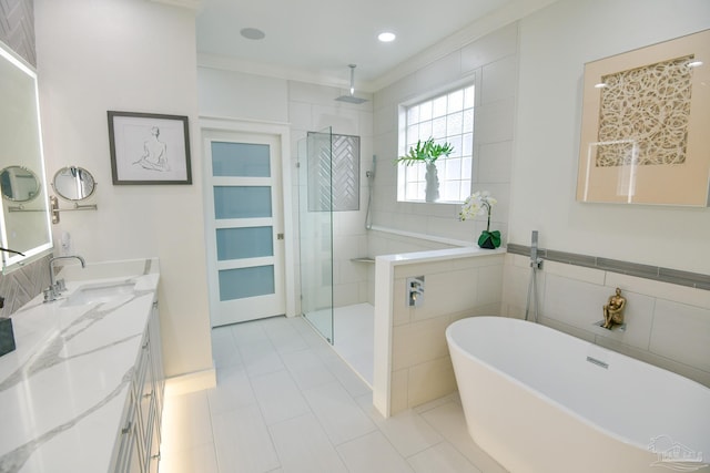 bathroom featuring vanity, tile patterned floors, ornamental molding, tile walls, and independent shower and bath