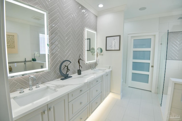 bathroom featuring backsplash, tile patterned flooring, vanity, and ornamental molding