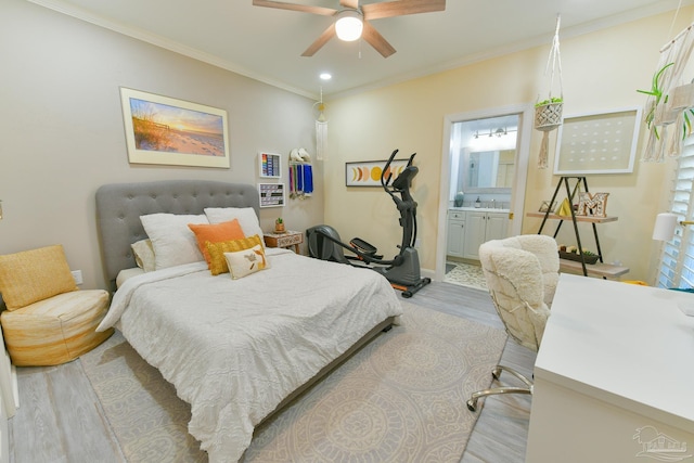 bedroom with light hardwood / wood-style floors, ensuite bath, ceiling fan, and crown molding