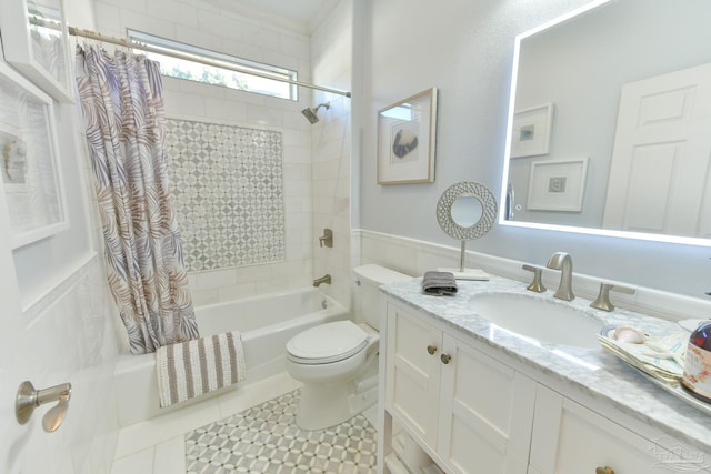 full bathroom featuring tile patterned flooring, vanity, toilet, and shower / bath combo with shower curtain