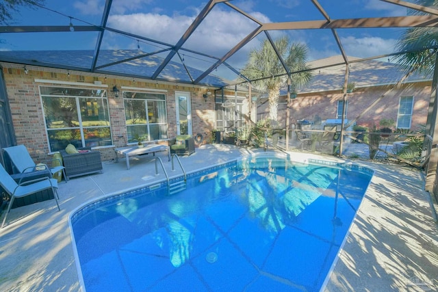 view of swimming pool featuring a lanai and a patio