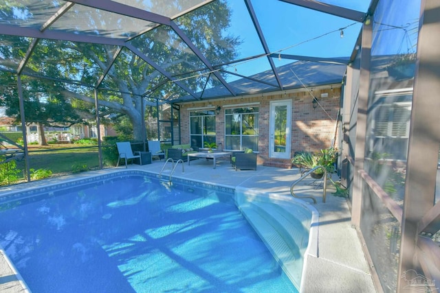 view of swimming pool with a lanai and a patio area