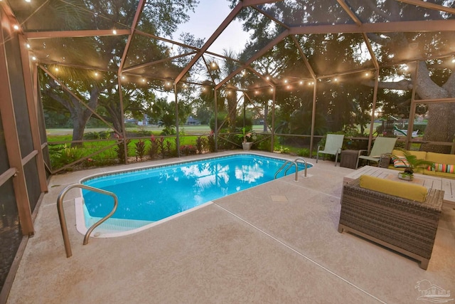 view of swimming pool featuring glass enclosure and a patio area