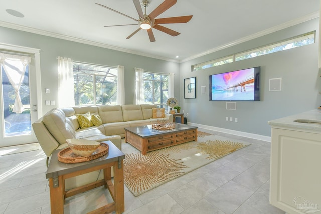 tiled living room featuring crown molding, sink, and ceiling fan